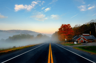 road with red house on the side